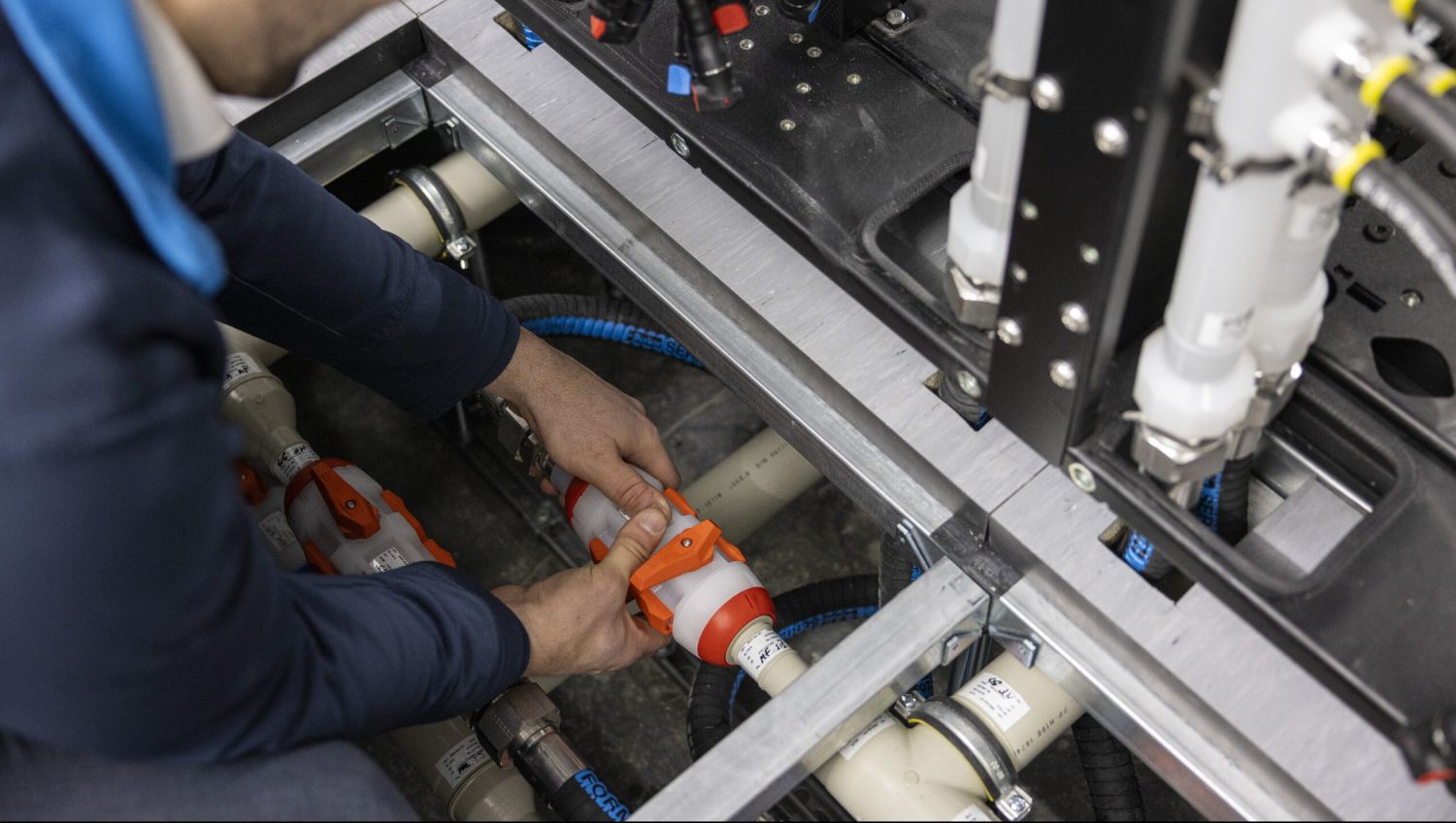 Technician servicing process cooling water piping